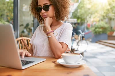 Woman at cafe coffee shop reading email